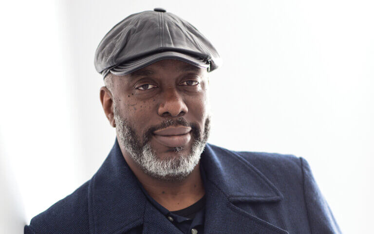 Photo of man in hat smiling